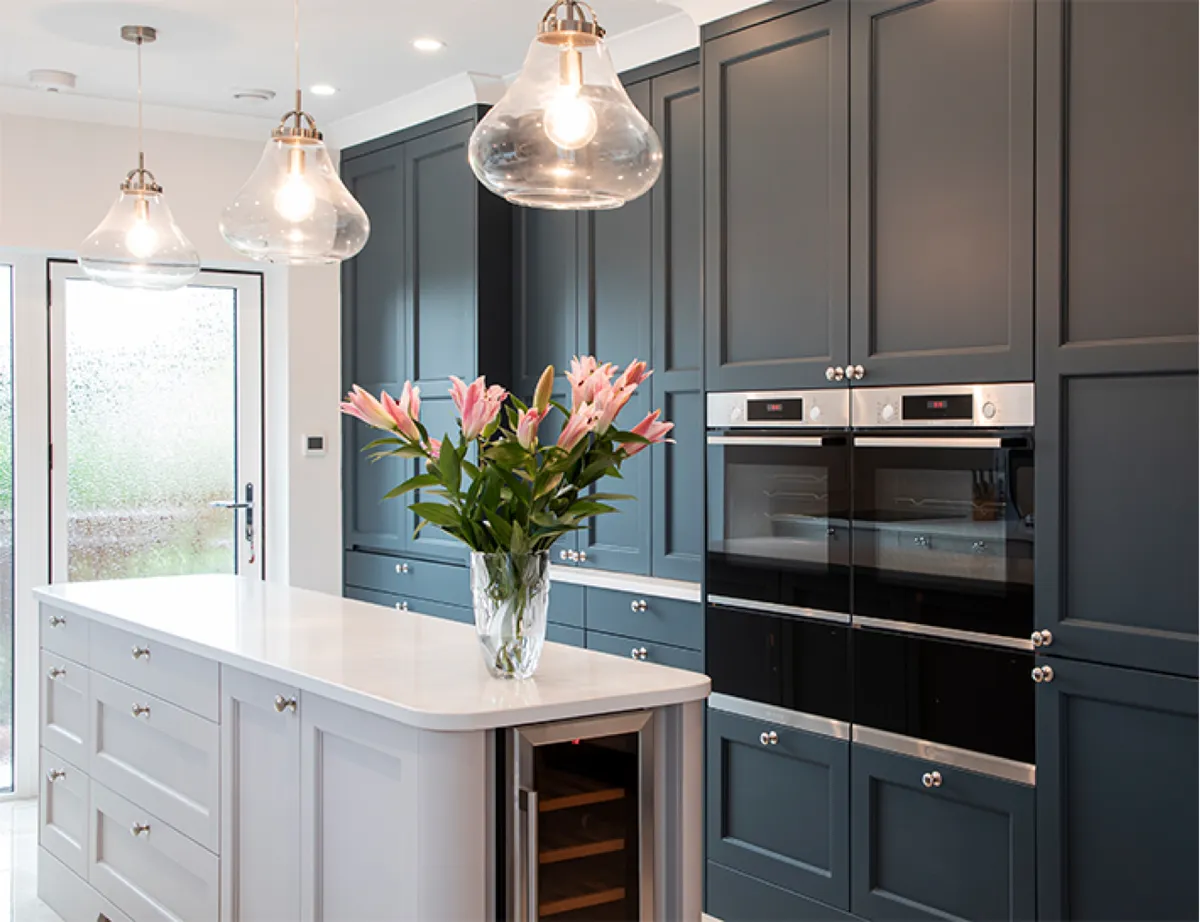 Dark grey shaker kitchen with a white island, wine cooler and pendant lights